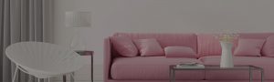 a living space with a pink sofa & rustic table