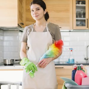 a woman holding cleaning duster